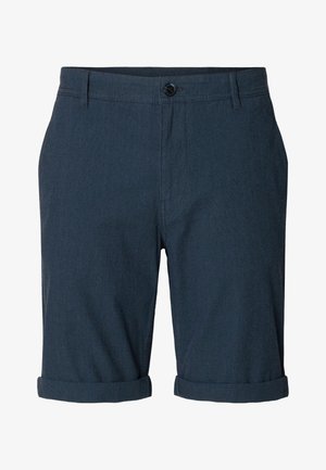 Sötétkék, textúrázott anyagból készült sportnadrág, gombos záródással, felgöngyölt szegéllyel és lapos elülső résszel. A képen láthatóan nincsenek zsebek.