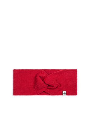 Red knitted headband with a twisted knot design at the center and a small white tag on the bottom right side.