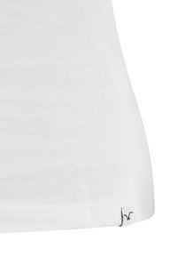 White cotton t-shirt featuring a slim fit, smooth texture, and a small logo tag on the lower hem. Simple design with no patterns.