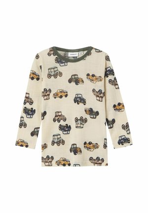 Long-sleeve shirt in beige fabric featuring a pattern of colorful, illustrated cars. Collar has a green trim; lightweight, textured material.