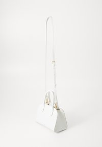 White leather handbag with a structured shape, featuring a double handle and a long adjustable strap. Gold hardware accents are present.