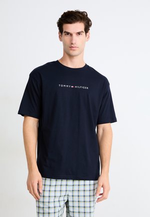 Navy blue cotton t-shirt with a crew neck and short sleeves, featuring a white and red "TOMMY HILFIGER" logo across the chest.