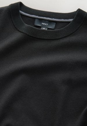 Črna jopica s krojnim ovratnikom iz gladkega blaga, z ribastim ovratnikom in manšetami, ter oznako blagovne znamke 'NEXT' in velikosti 'M'.