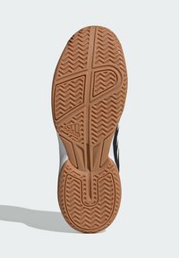 Black and white athletic shoe sole featuring a textured gum rubber pattern with a zigzag design and the adidas logo in the center.