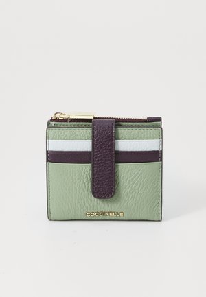 Green leather wallet with dark purple accents and white horizontal stripes. Features a zip closure and embossed logo on the front.