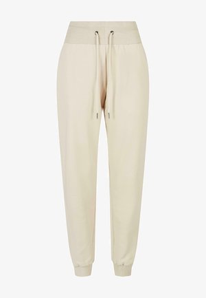 Svetlo béžové teplákové nohavice vyrobené z mäkkej tkaniny, s rebrovaným pásom, šnúrkou a elastickými manžetami na členkoch.