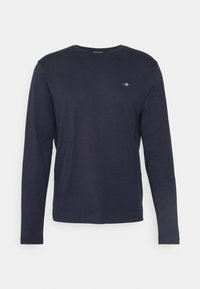 T-shirt à manches longues navy en tissu doux, avec un col rond, une coupe slim et un petit logo brodé sur la poitrine.