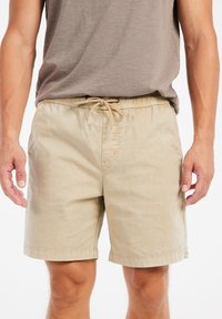Beige katoenen shorts met een elastische tailleband en koord. Inclusief zijzakken en een rechte snit met een afgewerkte zoom.
