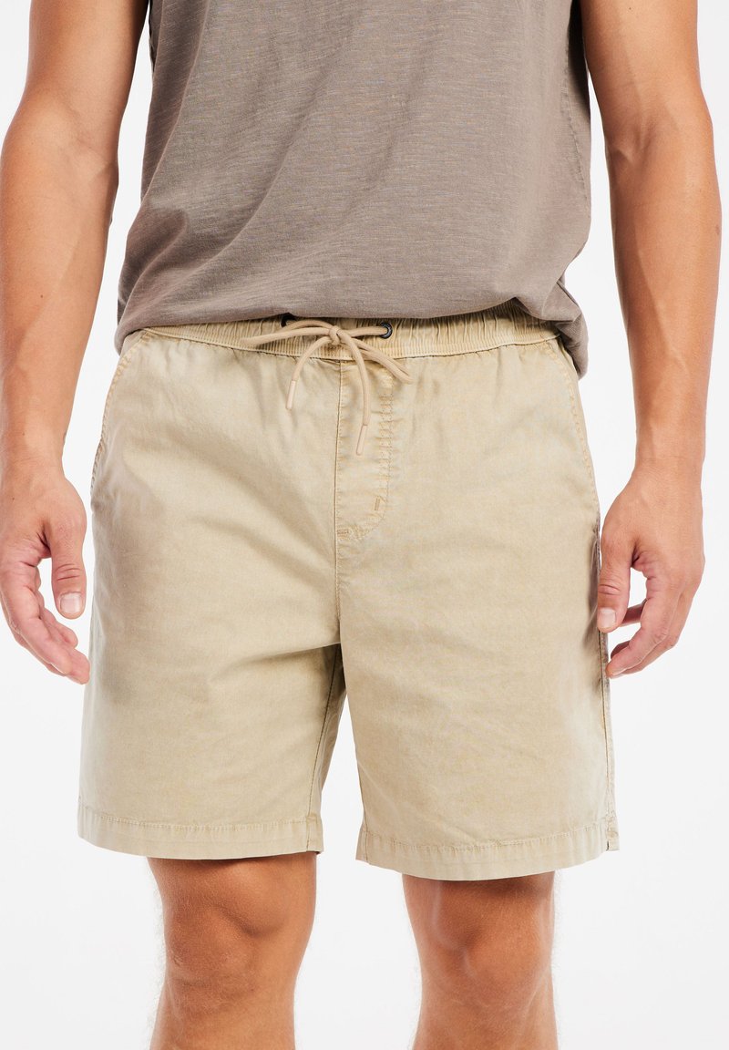 Beige katoenen shorts met een elastische tailleband en koord. Inclusief zijzakken en een rechte snit met een afgewerkte zoom.