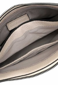 Cream leather clutch with a gray interior, featuring a zip closure and two compartments. Includes an embossed brand label inside.