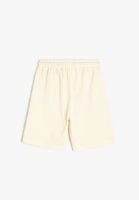 Lysegule shorts lavet af tekstureret stof med elastisk talje, der har en afslappet pasform og lige snit.