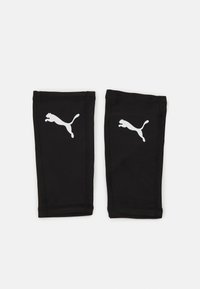 Manches de sport noires en tissu extensible, avec logo Puma blanc sur chaque manche. Design sans coutures avec une coupe ajustée.