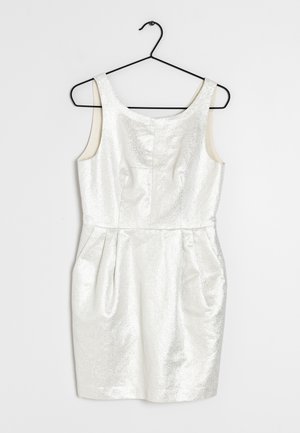 Sleeveless white textured sleeveless dress with a fitted waist hanging on a black wire hanger against a white background.