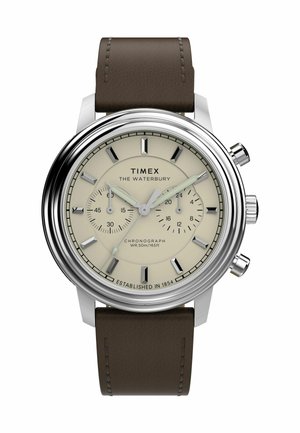Montre chronographe Timex Waterbury avec un boîtier en acier inoxydable, un cadran beige, un bracelet en cuir marron et des index horaires bien visibles. Résistante à l'eau jusqu'à 50 m.