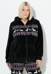 Sort fleece zip-up hættejakke med et mønstret bånd om livet, der prydes af hvide rensdyr og snemænd. Indeholder forlommer og hætte med snore.
