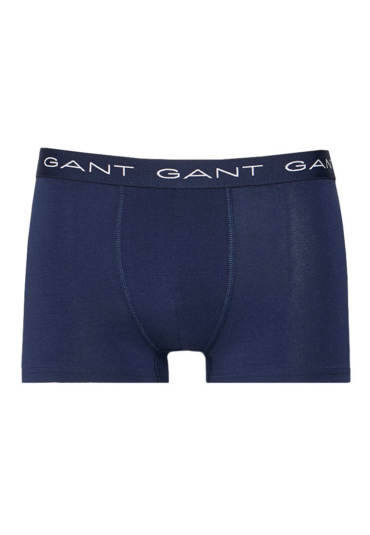 Marinblå kalsonger i mjukt material, med en svart midje med vit "GANT"-text och platta sömmar.