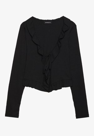 Must mustriba mustriga varrukatega pehme pinda ja figuuri rõhutava siluettiga must T-särk, millel on volangiga V-kaelus, esipoolsed nööride detailid ja lühike hem. Pehme tekstuur.