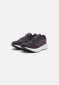 Purple mesh athletic shoes with black accents, textured surface, white midsole, and three black stripes on the sides. Curved toe and rubber sole.