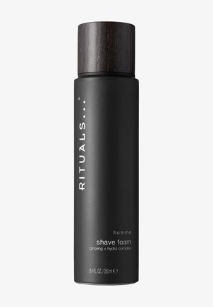 Cilindro negro con tapa de madera oscura. El texto dice "RITUALS homme espuma de afeitar ginseng + complejo hidra. 250 ml." Acabado mate.
