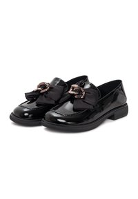 Black patent leather loafers with a round toe, featuring a large black bow accent and metallic chain detail on the front. Flat rubber sole.