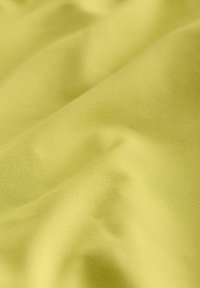 Měkká, texturovaná tkanina v jasně citronově žluté barvě se hladkými, plynulými vlnami a jemným leskem. Ideální pro oděvy nebo čalounění.