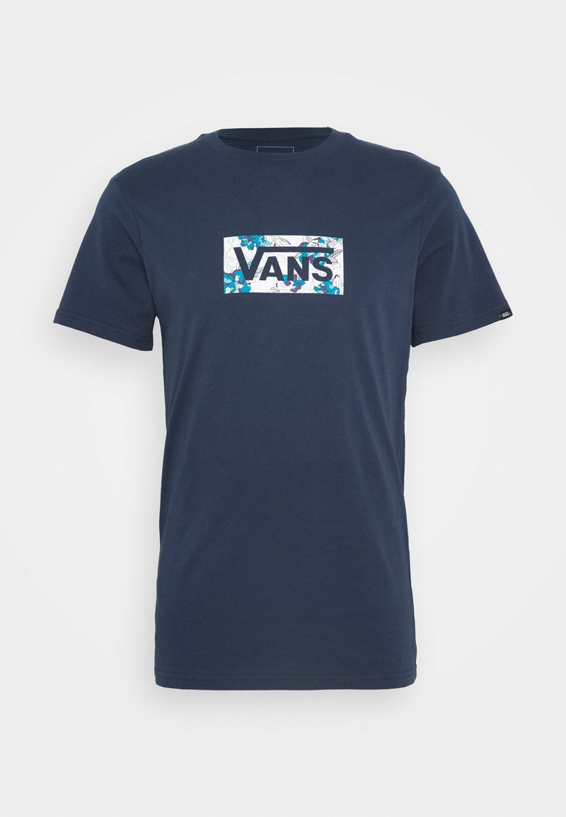 Marinblå t-shirt i bomull med en rektangulär vit grafik med blommönster och texten "VANS" i fet blå bokstäver.