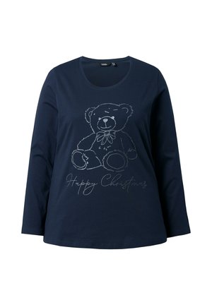 Camisa de manga larga azul marino con una ilustración en contorno gris de un oso de peluche con una pajarita y el texto "Feliz Navidad" debajo.