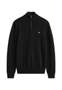 Jersey negro de punto con mangas largas, cuello, puños y bajo de canalé, con cremallera frontal a medio lado y un pequeño logo bordado en el pecho.