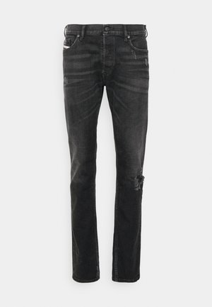 Black denim jeans with a straight fit, featuring distressing at the knee, five-pocket design, and subtle fading in the fabric texture.