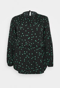 Schwarze Bluse mit langen Ärmeln und hohem Kragen, ausgestattet mit einem Peplum-Taille und verstreuten mintgrünen Punkten. Schlüssel ausschnitt im Rücken.