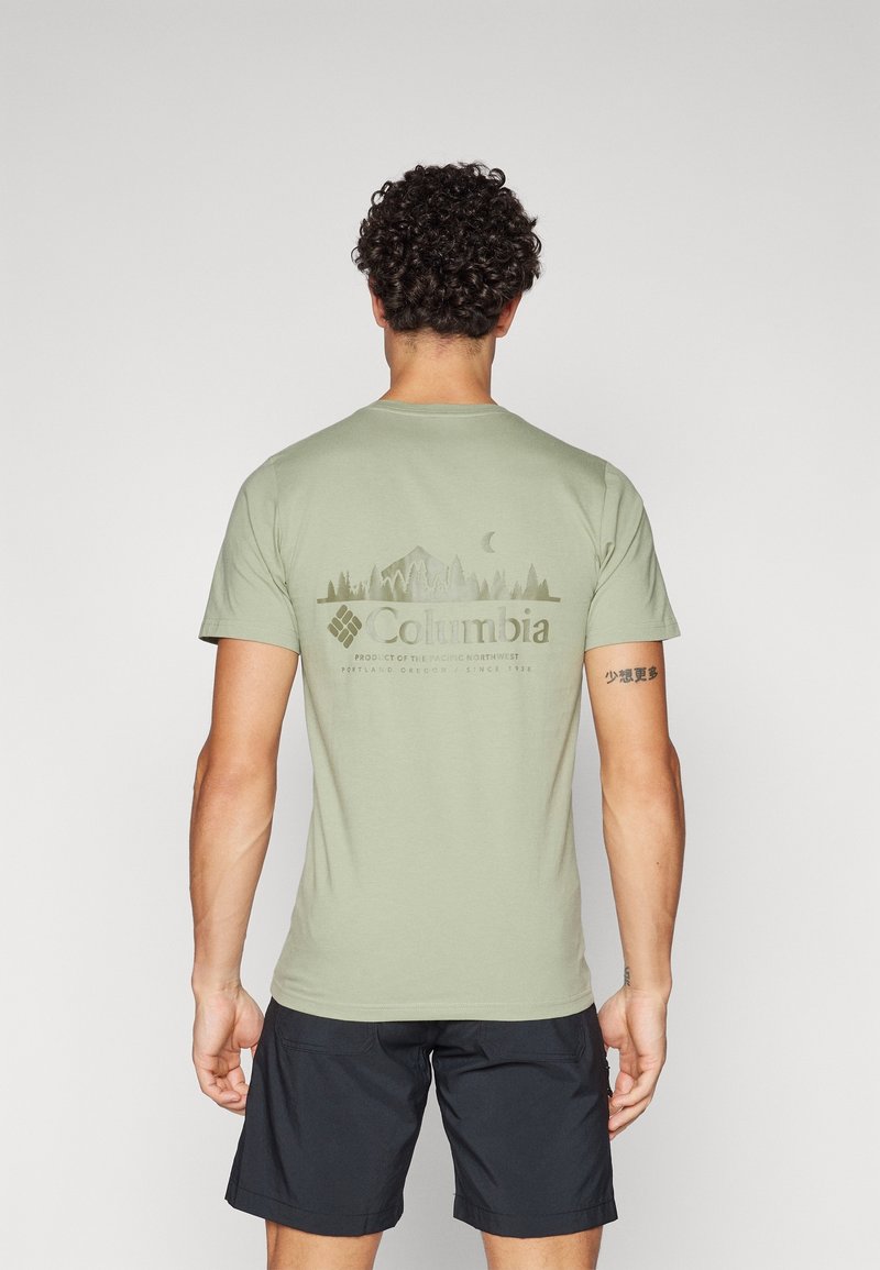 Light green cotton t-shirt with short sleeves, featuring a nature-themed graphic in dark green on the back, branded with "Columbia."