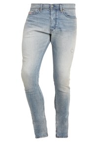 Ljusblå denim skinny jeans med lätt blekning, en slitdetalj på låret, en klassisk femfickdesign och standard knappstängning.
