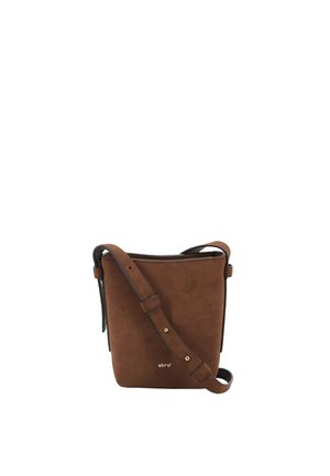 Brown suede crossbody bag with a structured design, adjustable strap, and subtle branding. Includes metal accents and smooth lining.
