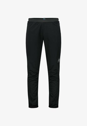 Pantalons de plein air noirs à coupe fuselée, avec une taille élastique et des poignets zippés. Fabriqués à partir d'un matériau léger et résistant à l'eau. Logo sur le côté.