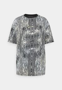 Koszulka z krótkim rękawem z nadrukiem w czarno-białe węże, okrągły dekolt i luźny krój. Miękka tkanina o gładkiej fakturze.