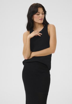 Black knitted tank top with a ribbed texture, paired with a similarly textured black skirt. Both pieces have a fitted design.
