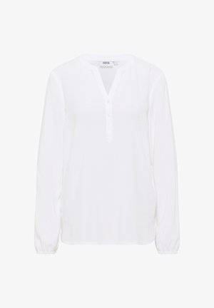 Weiße Bluse mit langen Ärmeln, V-Ausschnitt, Knopfleiste und elastischen Bündchen. Hergestellt aus leichtem, glattem Stoff und mit einem lockeren Schnitt.