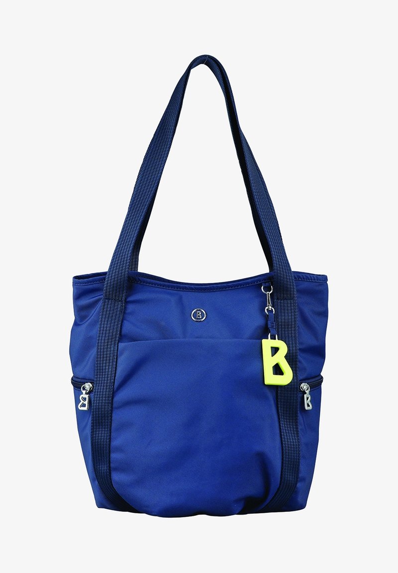 Sac cabas bleu marine avec larges bretelles, poche avant, fermetures éclair argentées, logo rond et porte-clés jaune en forme de lettre B suspendu à la sangle.