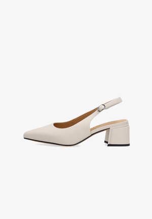 Beige pointed-toe slingback shoe with block heel and adjustable silver buckle strap, smooth leather finish.