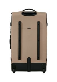 Beige rolling suitcase with black handles, wheels at the base, and two vertical black protective strips on the back panel.