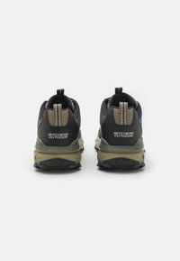 Black and olive green Skechers outdoor shoes featuring textured fabric, a cushioned sole, and a pull tab at the heel.
