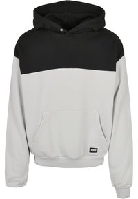 Hooded sweatshirt with a gray body and black top section, featuring a front pocket and ribbed cuffs. Made from soft textile material.