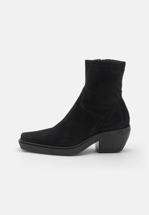Black suede ankle boot with pointed toe and block heel, side zipper closure, and smooth sole for casual or dress wear.