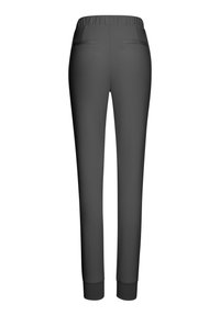 Gray jogger pants with an elastic waistband, tapered legs, and two back pockets. Made from smooth, stretchable fabric with ribbed cuffs.