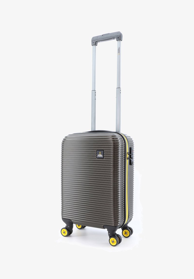 Hard-shell suitcase with a ribbed design in dark gray, yellow accents, retractable silver handle, and four yellow wheels for mobility.
