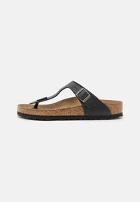 Black thong sandal with a cork footbed, adjustable strap with a metal buckle, and textured rubber outsole. Flat design with a minimalist look.