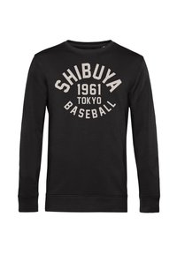 Černá mikina s dlouhými rukávy vyrobená z měkké tkaniny, s kulatým výstřihem. Přední design obsahuje bílé písmo: "SHIBUYA 1961 TOKYO BASEBALL."
