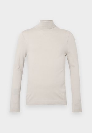 Ljusbeige polotröja i mjuk tyg, med långa ärmar och en figursydd design, med ribbade detaljer vid halsen och ärmsluten.