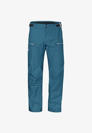 Pantalones de esquí azules impermeables con un acabado texturizado, cintura ajustable y dos bolsillos con cremallera en el frente. Costuras y perneras reforzadas.