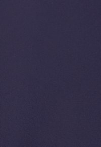 Tessuto di un profondo blu navy con una superficie liscia, che mostra sottili variazioni di tonalità. Nessun motivo visibile o dettagli hardware.